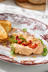Hummus with tomatoes and toast, bright natural light, closeup plate composition