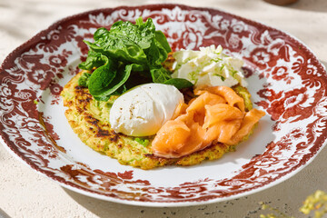 Zucchini draniki with salmon and poached egg, bright rustic lighting, closeup composition