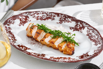 Grilled chicken fillet with spinach, bright natural lighting, overhead composition