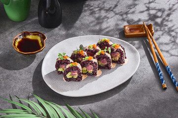 Wild rice maki sushi rolls with tuna and avocado, bright overhead, minimalist modern Japanese...