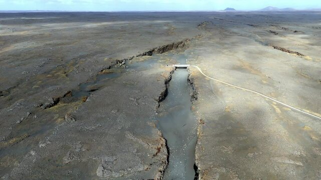 The Bridge between Continents footbridge spanning a rift between the Eurasian and North American tectonic plates aerial footage