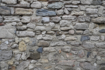 Detailed view of an ancient stone wall in a rustic setting