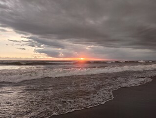 Beautiful landscape photography on the beach at golden hour sunset.
Dramatic sea sunset with reflection of sunlight over water surface.