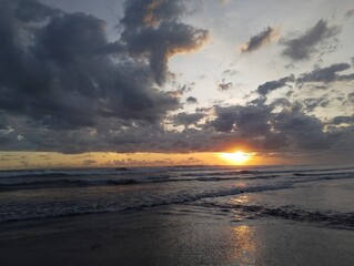 Beautiful landscape photography on the beach at golden hour sunset.
Dramatic sea sunset with reflection of sunlight over water surface.