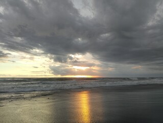 Beautiful landscape photography on the beach at golden hour sunset.
Dramatic sea sunset with reflection of sunlight over water surface.