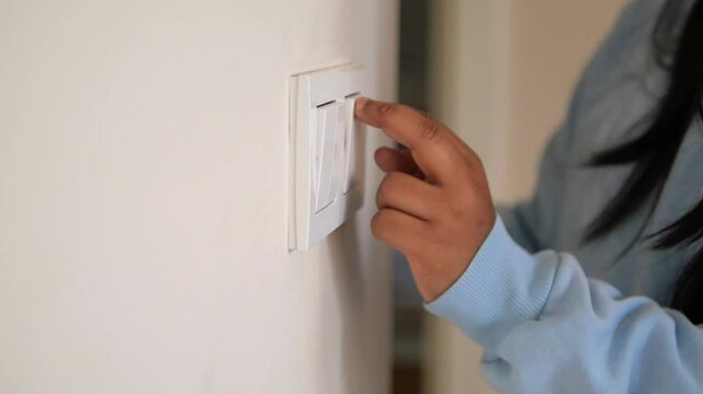 a child is reaching out to turn on the light switch in their room