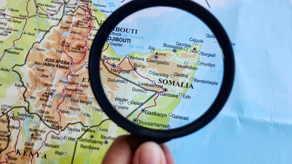 View of Somalia, on a geographic map of Africa, seen using a magnifying glass