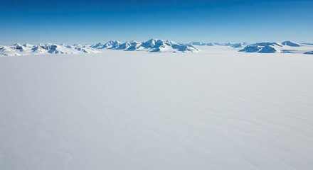 Vast expanse of pristine ice. Snowy mountains in the distance