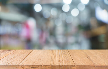 Empty wood table top and blur of restaurant background selective focus product display
