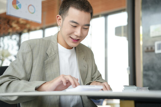 Confident asian business man Auditor or internal revenue service staff checking annual financial statements company Audit  Accounting tax
