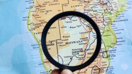 Obraz premium View of Botswana, on a geographic map of Africa, seen using a magnifying glass