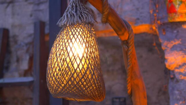 Beautiful woven lamp illuminates rustic setting