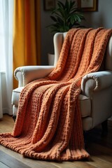 Cozy Oversized Knit Blanket Draped on Plush Armchair in Soft Light, Evoking Warmth, Comfort, and Relaxation Perfect for Autumn or Winter Home Scenes