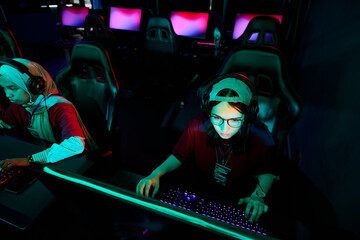 Diverse team of young adult and teenager girls including Asian and Caucasian gamers wearing...