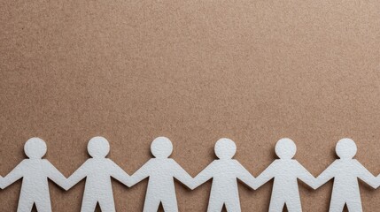 Paper cutout figures holding hands in a row against a brown textured background, symbolizing unity and teamwork.
