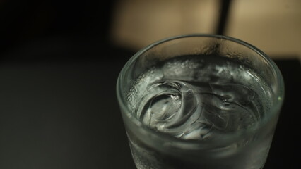 Close-up of a glass of cold water with ice cubes