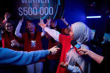 Group of multiethnic teenage girls gamers celebrating esports tournament victory, smiling and...