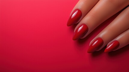 Manicured female hand with glossy red almond nails.