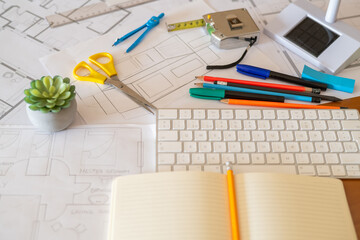 Desk of architect designing sustainable building with eco-friendly materials using computer...