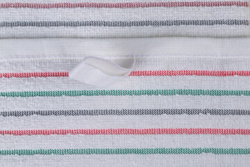 multi-colored striped terry towels for the kitchen with a loop for hanging on a hook, isolated