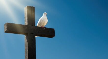 A serene white dove perched atop a wooden cross against a clear blue sky, symbolizing peace and hope