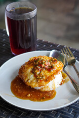 Pontianak Egg Rice, West Kalimantan, Indonesia, captured on July 4, 2025. Rice dish with fried egg, soy-based sauce, and crispy shallots for a simple yet bold flavor.