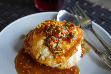 Pontianak Egg Rice, West Kalimantan, Indonesia, captured on July 4, 2025. Rice dish with fried egg,...