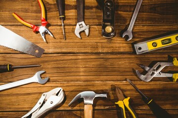 hand tools are being shown in flat design on wooden workbench with hammer, pliers, copy space