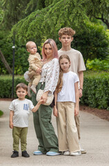 A woman with a baby and four children posing for a picture