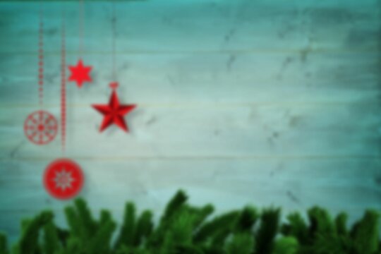 Fototapeta Blurred christmas decorations hanging over wood