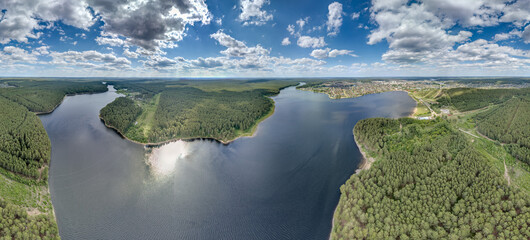Big lake with green shores in bright sun light, aerial landscape. Recreation concept. Aerial view