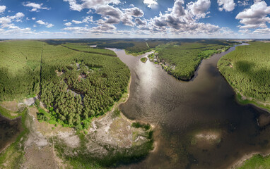 Big lake with green shores in bright sun light, aerial landscape. Recreation concept. Aerial view