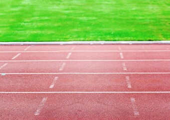 Flat design is showing red track lanes with white markings over grass field, transparent background