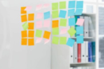 Adhesive note on glass wall in office