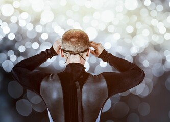 Rear view of swimmer against digitally generated lens flare