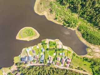 Aerial view of lake or river green shore with forest. Summer season.