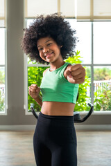 Vertical cheerful young afro hair boxing girl doing exercise in house gym