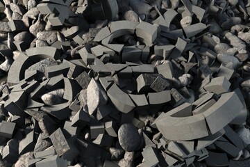 broken concrete fragments and smooth stones are showing flat design on rubble with angular shards