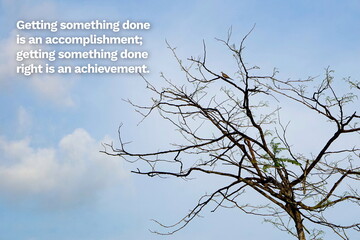 Inspirational life quote on blurry background. Getting something done is an accomplishment; getting...