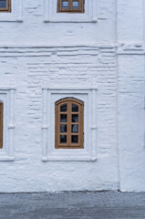 Window of the old 17 century building. Old stone wall with window