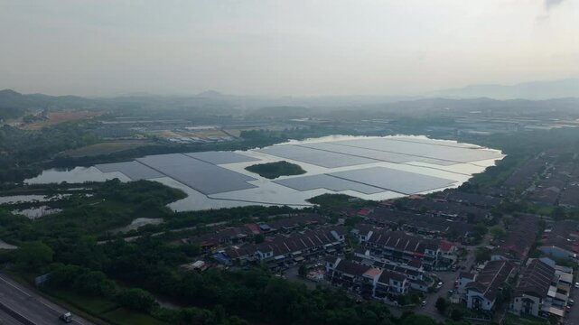 Aerial view of a floating solar panel farm concept on a serene tropical lake in Rawang, Malaysia. Clean renewable energy landscape in Southeast Asia.