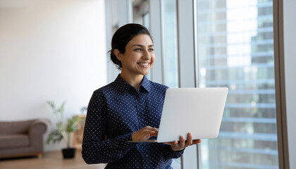 Business woman using laptop computer typing in modern office. 