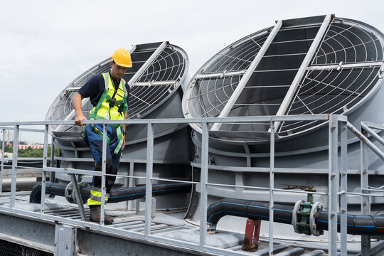 Cooling tower operations, Legionnaires disease prevention.
Engineer or technicians maintenance and repair of cooling towers for preventing issues Legionella growth on rooftop of building