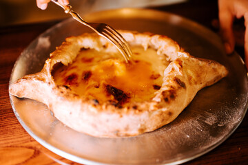 Delicious Adjarian Khachapuri served warm on a plate ready to be enjoyed