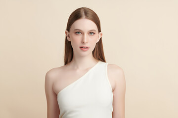 A beautiful young woman with clean, fresh skin against a beige background. Skincare, facial...