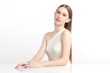 A beautiful young woman with clean, fresh skin against a white background. Skincare, facial...