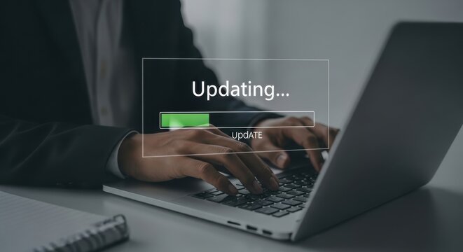 A man updates his laptop with a progress bar on the screen