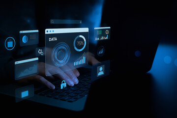 Hands typing on a laptop with digital data and graphs displayed