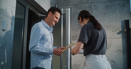 Female Postal Worker Delivering Small Parcel for Recipient in Modern Office, Getting Client's Signature. Businessman Taking Padded Envelope with Online Shopping Order. Delivery or Postal Service.