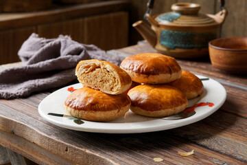 Close Up of Traditional Tau Sar Piah Chinese Pastry with Mung Bean Filling on Rustic Surface